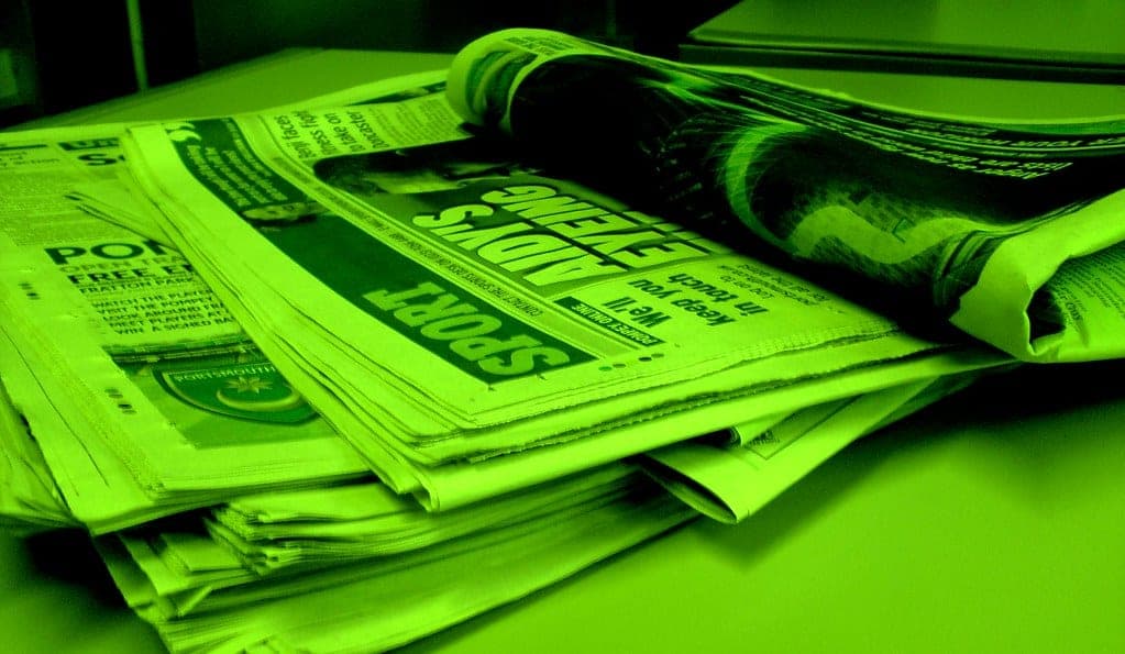 A stack of printed newspapers